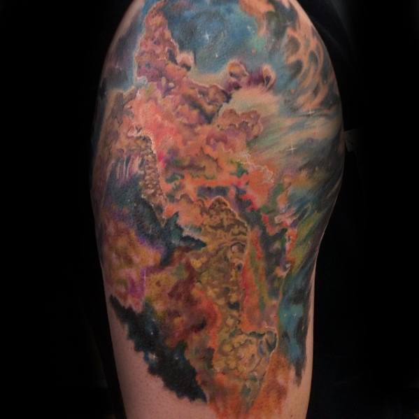 Nebula-inspired tattoo art with swirling patterns, vibrant colors covering an upper arm
