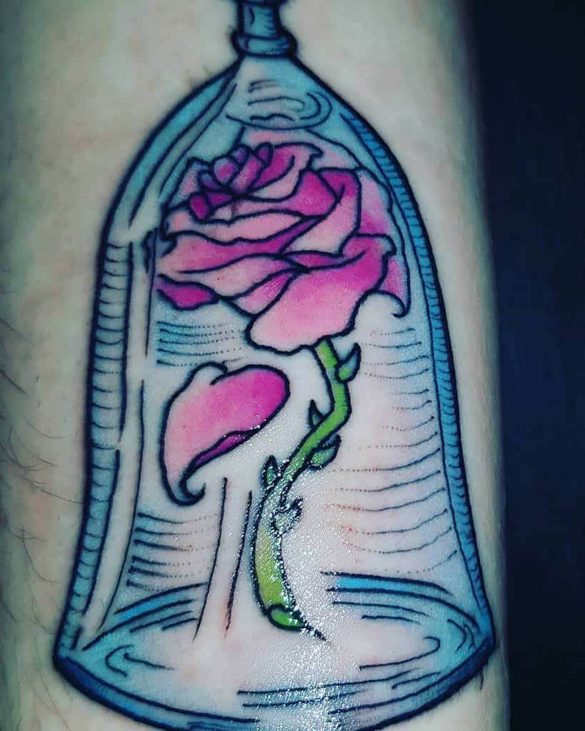 Tattoo of a pink rose under a glass dome