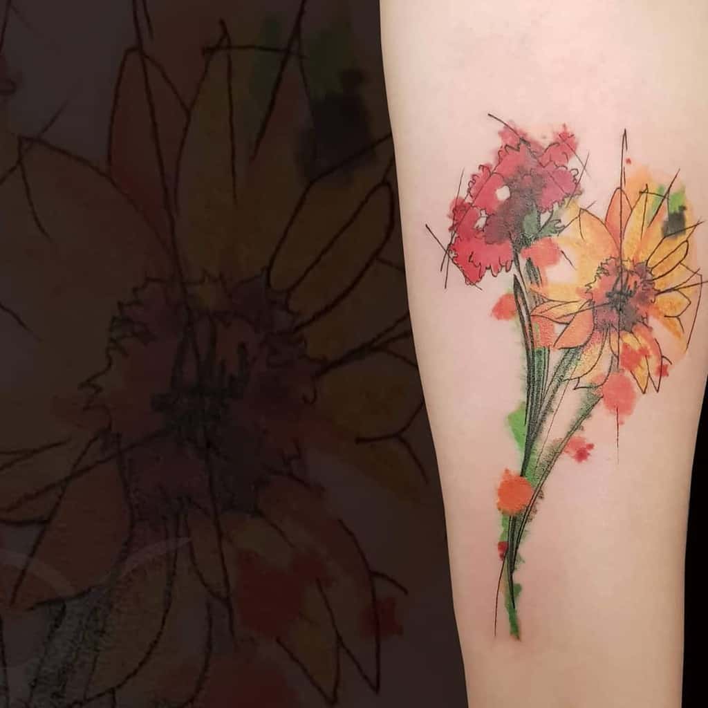 Watercolor tattoo featuring vibrant orange and red flowers with a sketch-like outline, creating a soft, artistic effect