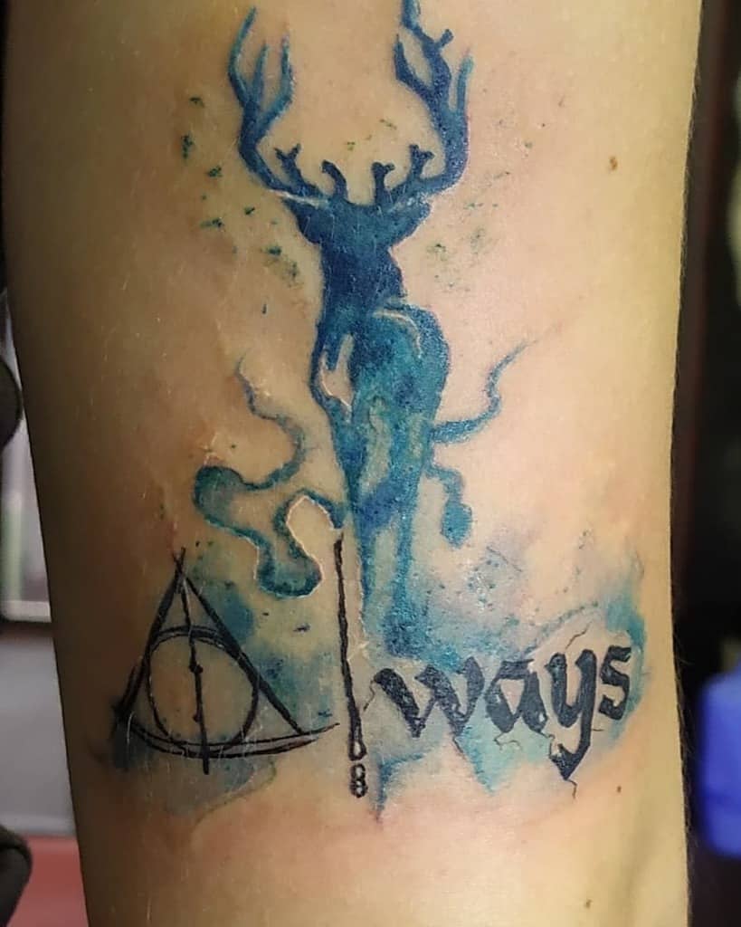 Harry Potter-themed tattoo with a blue stag Patronus, Deathly Hallows symbol, and 'Always' in gothic script, watercolor style