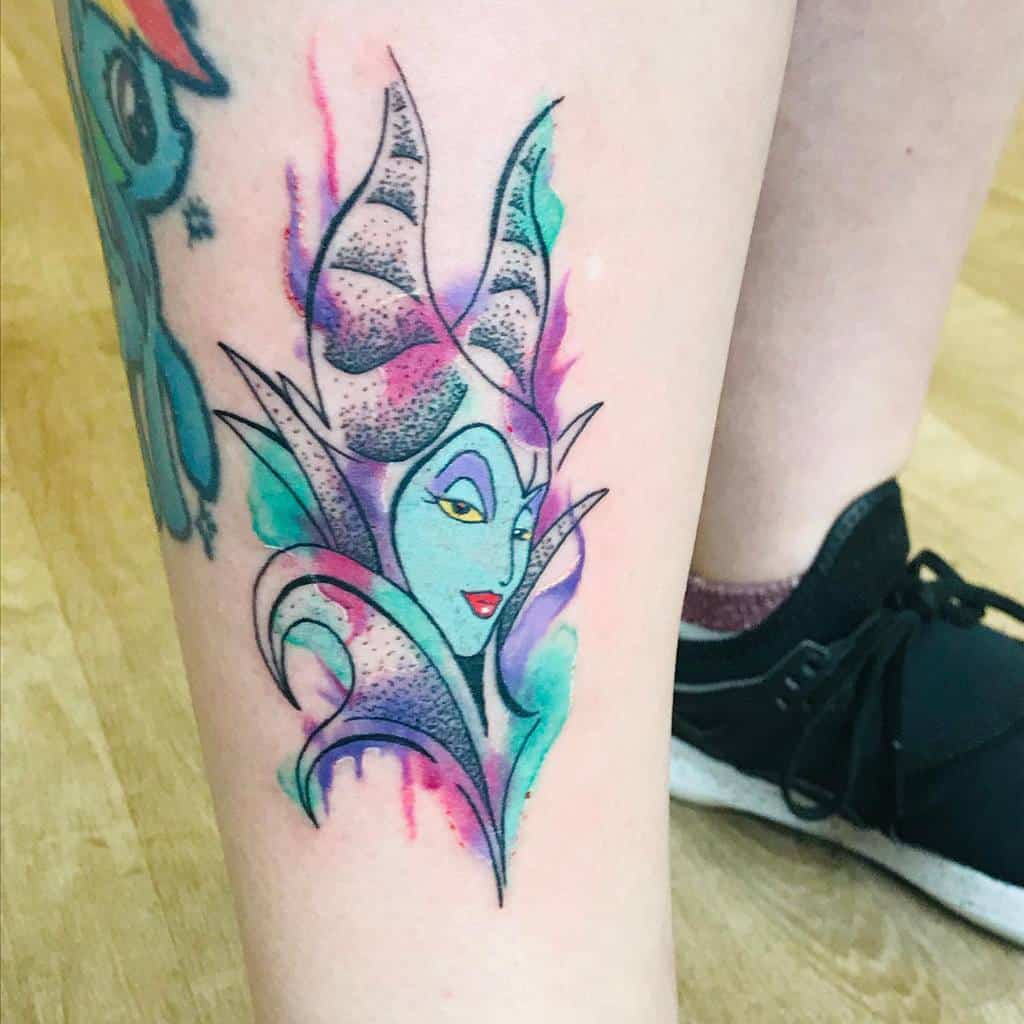 Vibrant watercolor Maleficent tattoo with dreamy pastel hues of pink, blue, and purple, blending seamlessly for a magical effect