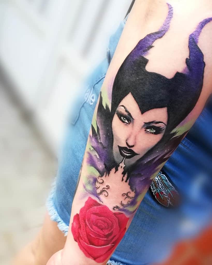 Vibrant Maleficent tattoo combining watercolor effects with a detailed rose, embodying beauty and dark elegance