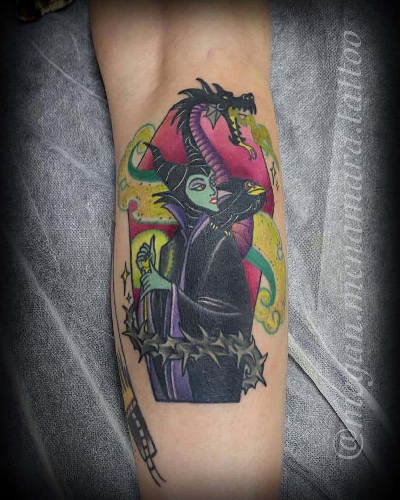 Vibrant Maleficent tattoo featuring her iconic dragon form, staff, and dynamic magical elements in bold colors