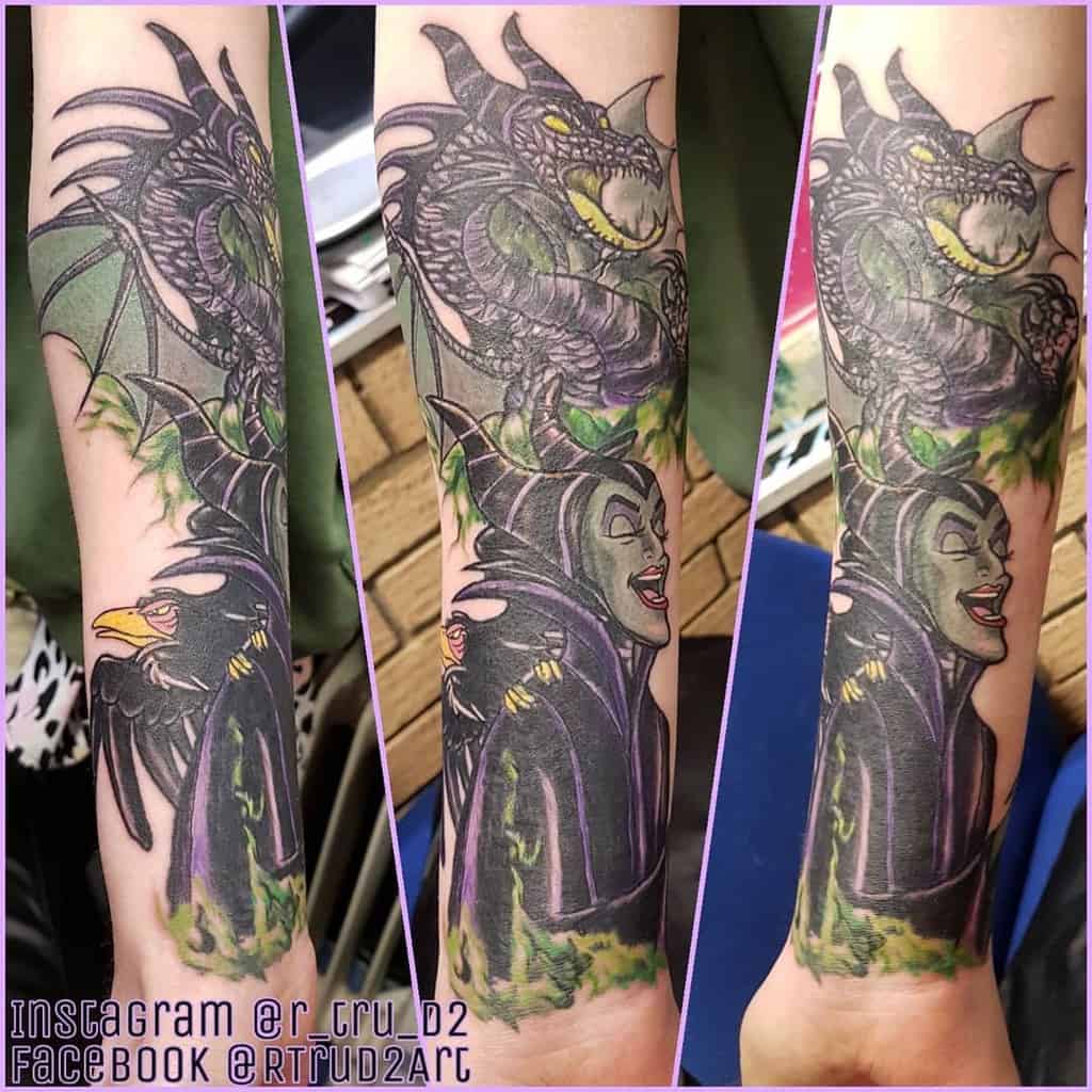 Dynamic forearm tattoo featuring Maleficent, her dragon, and crow, surrounded by vibrant green and purple tones for a magical theme