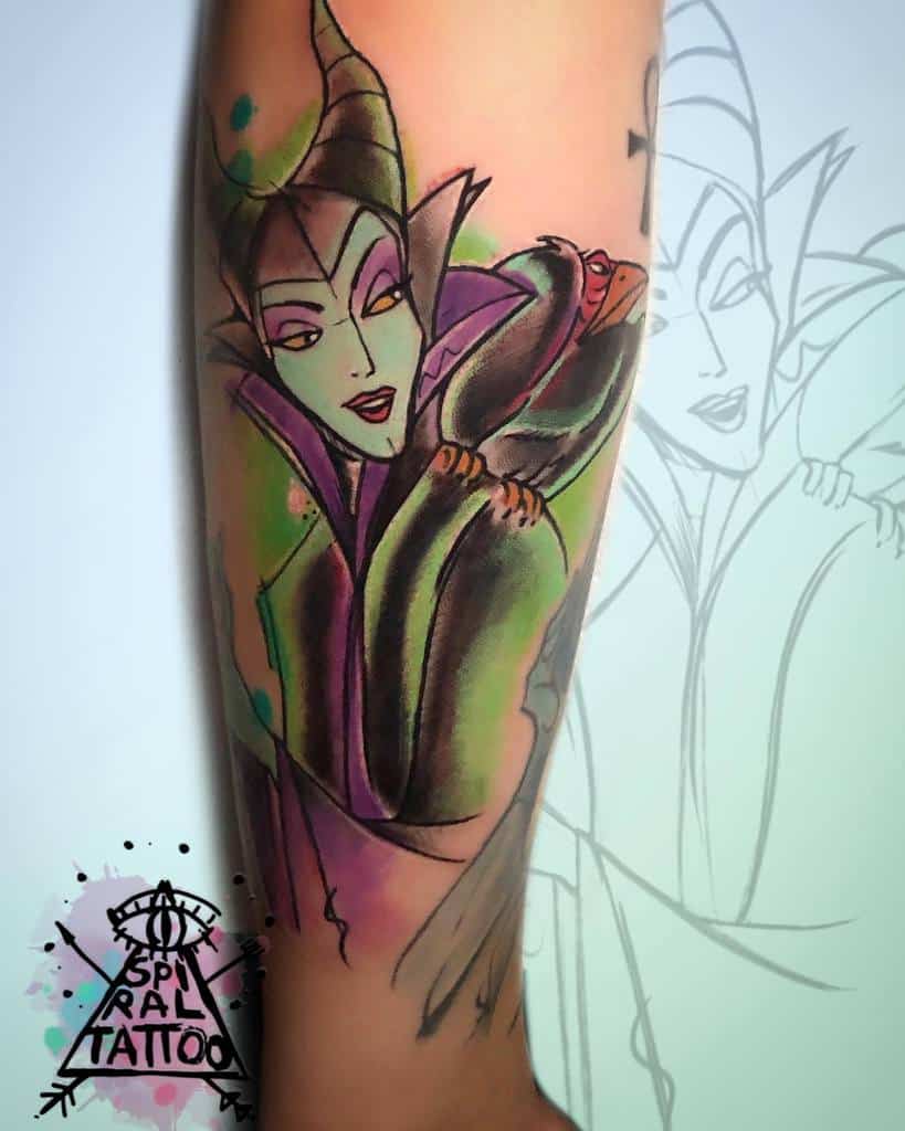 Watercolor-style Maleficent tattoo with vibrant green and purple hues, blending soft shading and bold lines for a striking artistic effect
