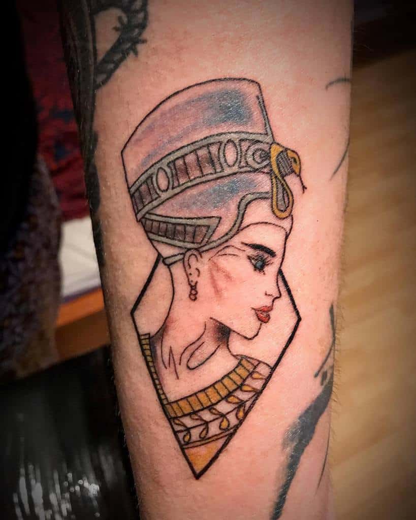 Tattoo of an ancient Egyptian queen with a headdress and earrings on an arm