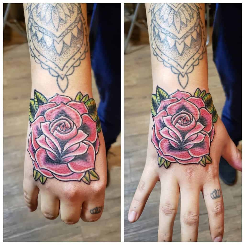 Hand with detailed henna and rose tattoo