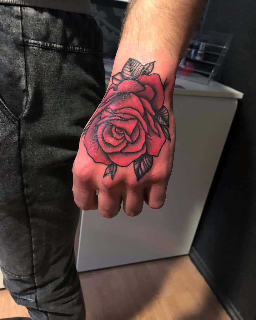 Red rose tattoo on the back of a hand