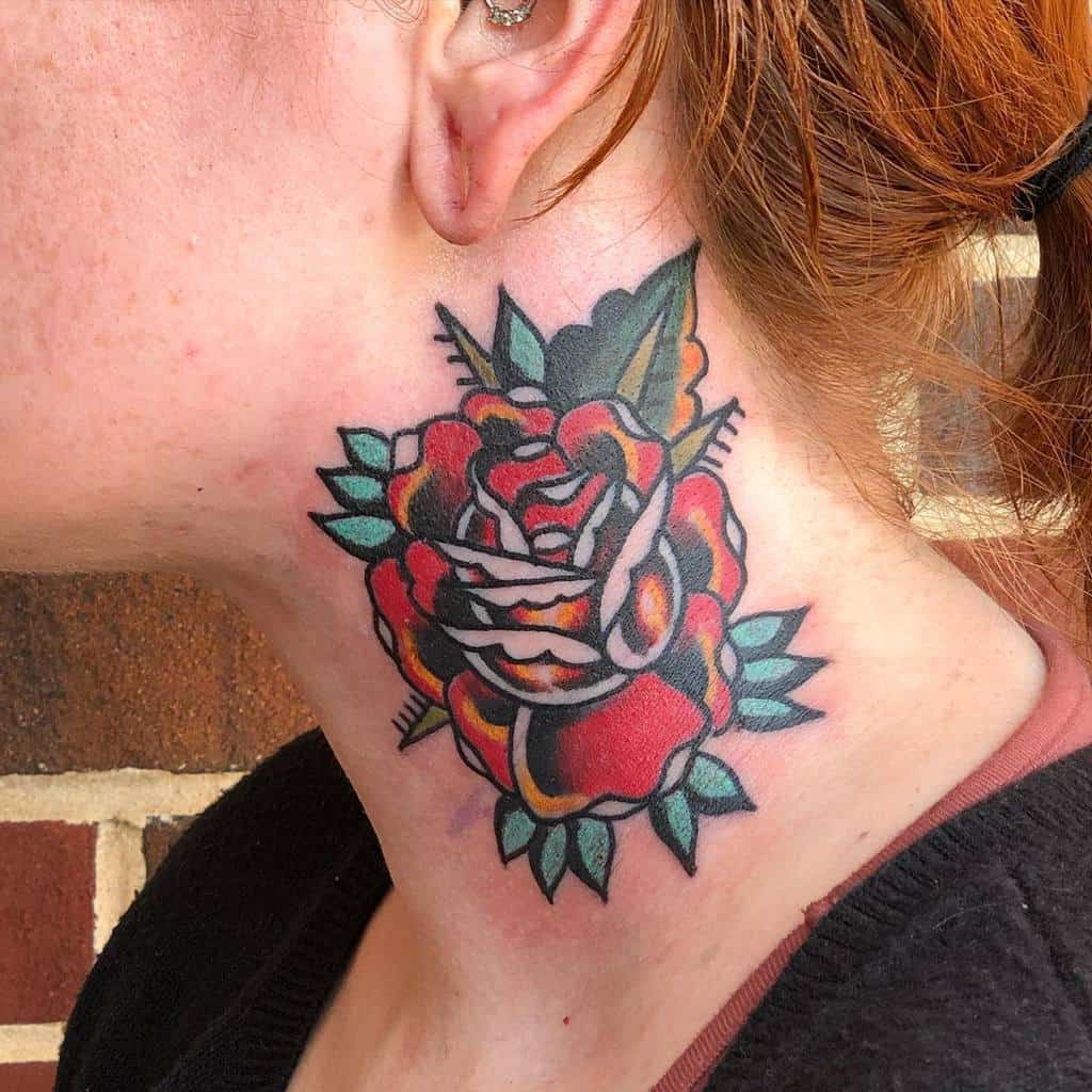 A vibrant rose tattoo graces the side of a woman's neck, with lush leaves and a snake intertwined, creating an exquisite design