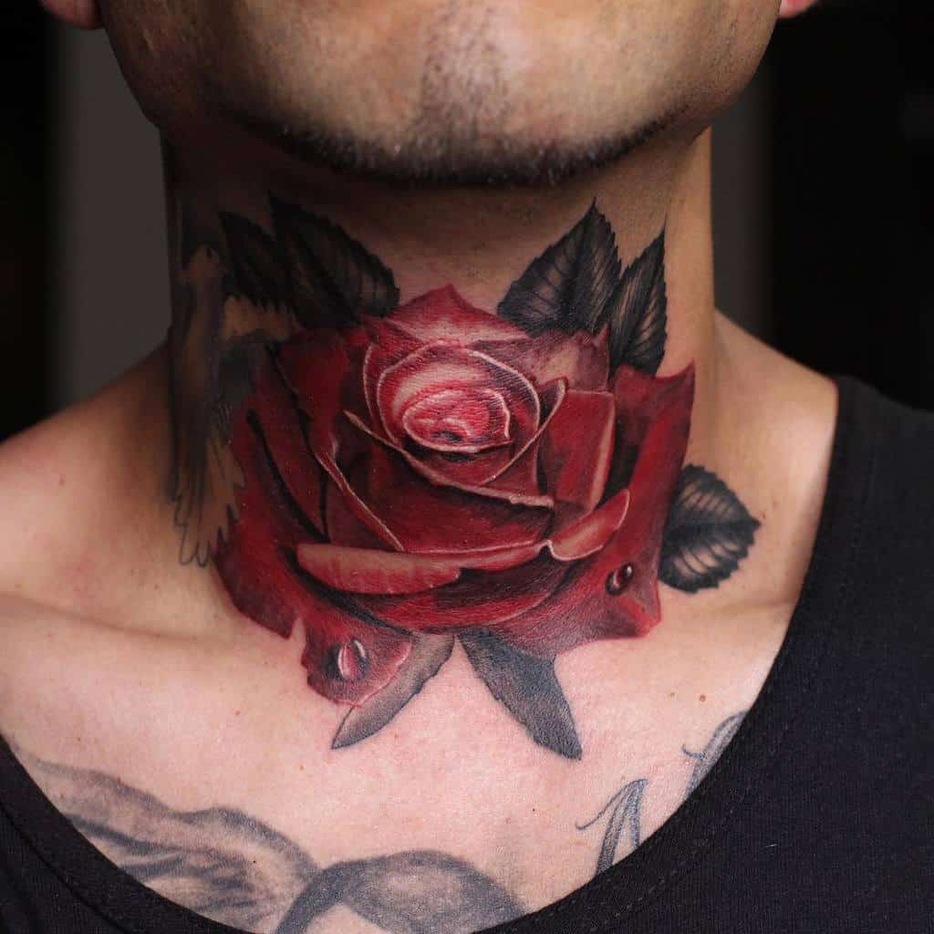 Neck tattoo of a detailed red rose with green leaves