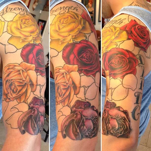 A colorful rose sleeve tattoo featuring yellow, red, and purple roses with a "Strength" inscription above