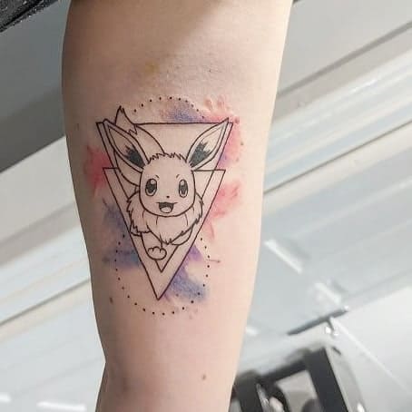 Geometric Eevee tattoo framed by a triangle, accented with subtle watercolor splashes in pink and purple for a modern look