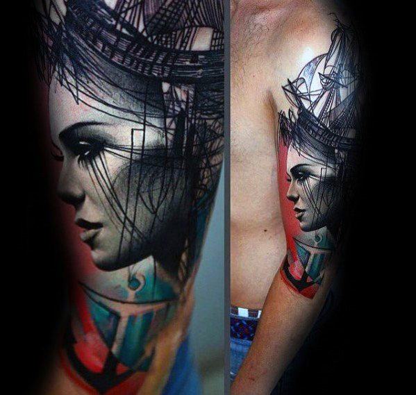 Abstract portrait tattoo of a woman's face with ship and an anchor on a person's arm