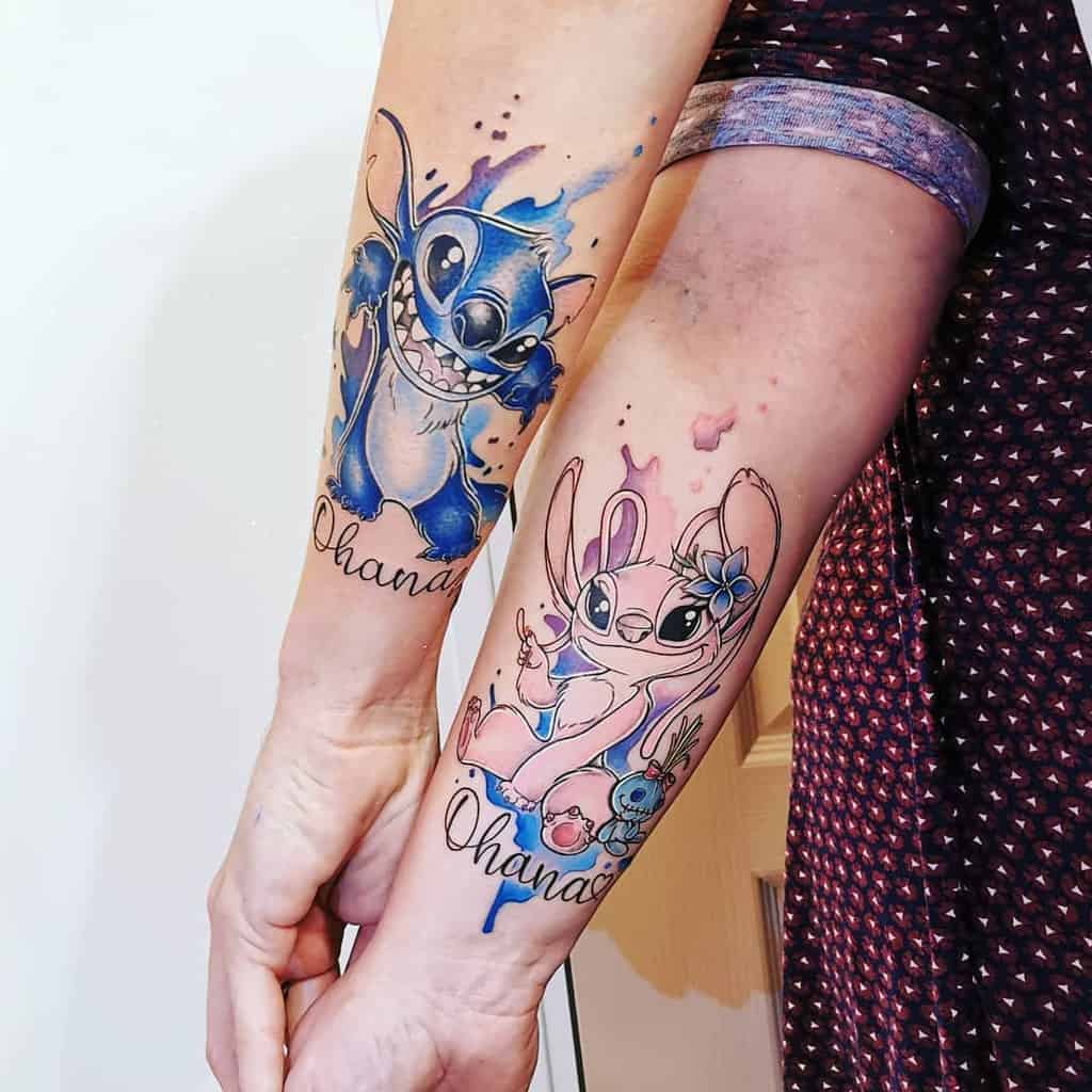 Colorful tattoos of Stitch and Angel from Lilo & Stitch with 'Ohana' below, on the forearms, with watercolor splashes and accents.