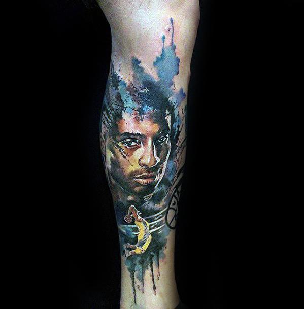 A colorful tattoo of Kobe Bryant, blending his portrait with an artistic splash effect and a dynamic basketball pose, showcasing his legacy and impact.