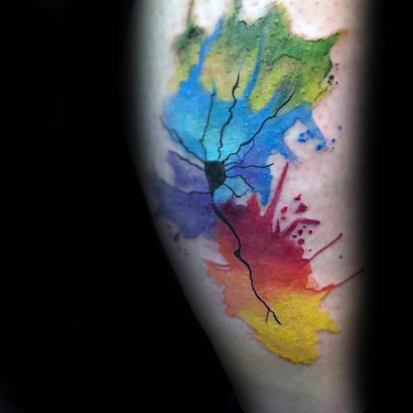 Watercolor-style neuron tattoo with a black outline and vibrant splashes of green, blue, purple, red, orange, and yellow.