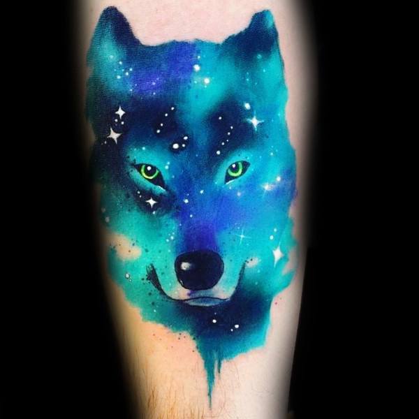 Vibrant galaxy-themed Siberian Husky tattoo, featuring a cosmic blue and green color palette with glowing eyes and starry details for a mystical look.