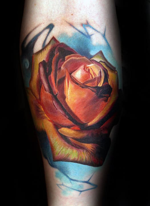 Colorful rose tattoo with vibrant hues on forearm
