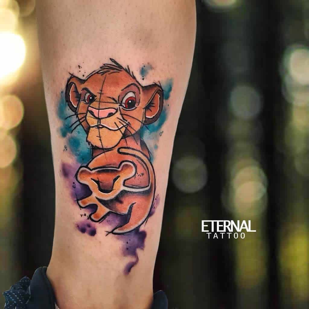 Colorful tattoo of Simba with watercolor splashes in shades of blue and purple with his chibi version