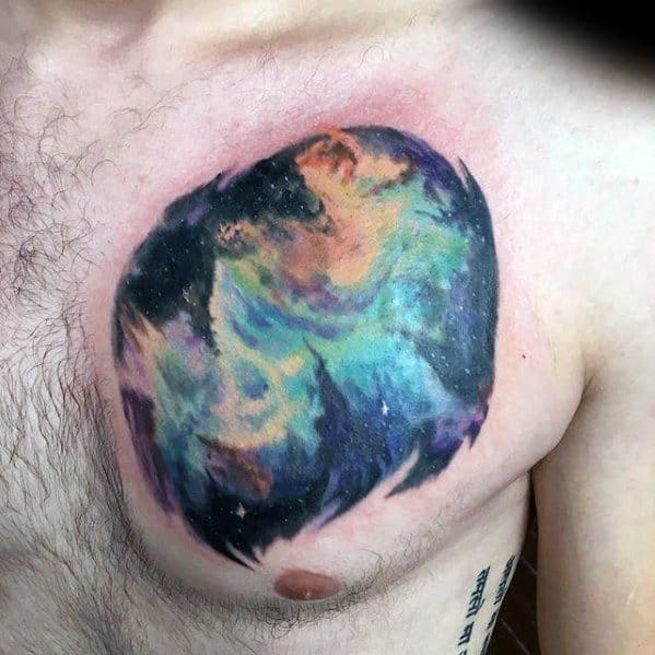 A colorful nebula tattoo on a person's chest, featuring swirling blues, purples, and oranges
