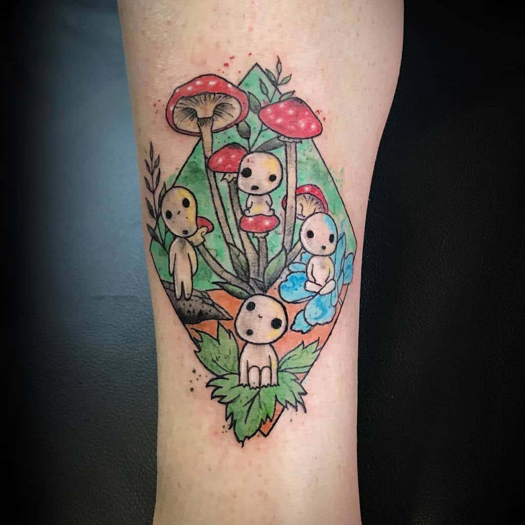 Colorful tattoo of kodama spirits surrounded by vibrant red mushrooms, blue flowers, and green leaves, with geometric patterns in the background.