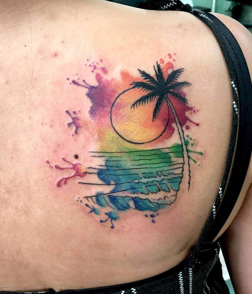 Watercolor-style tattoo of a tropical beach scene, featuring a black palm tree, ocean waves, and a sun, with vibrant rainbow splashes