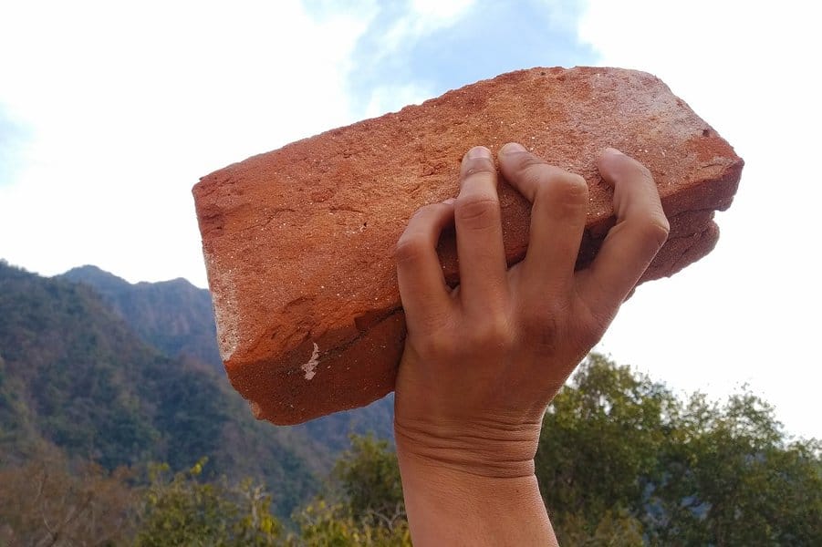 waved his hand with a brick