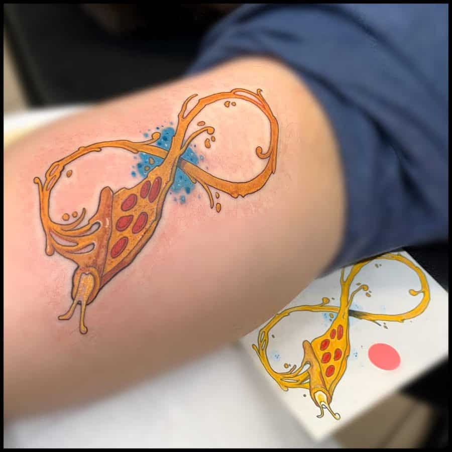 This tattoo features a whimsical design where the infinity symbol is creatively shaped to resemble a snail with a vibrant orange shell. The swirling lines, coupled with the playful yellow and orange hues, form a unique and artistic take on the traditional infinity symbol, suggesting ideas of continuous movement and growth, possibly infused with a fun and carefree spirit.