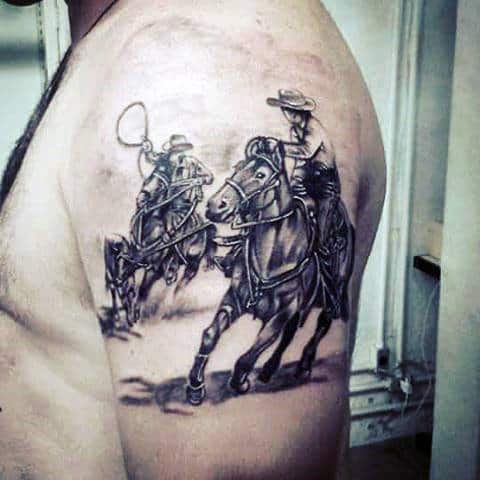 Western Men Chasing On Horse With Lasso Tattoo In Black And Grey