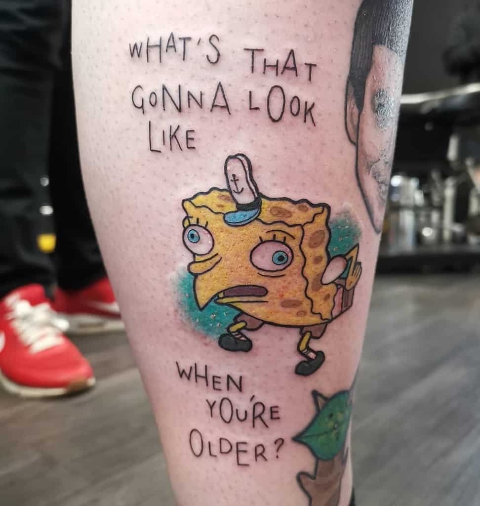 A colorful tattoo of a distorted cartoon sponge character with the phrase 'What's that gonna look like when you're older?' in a humorous style.