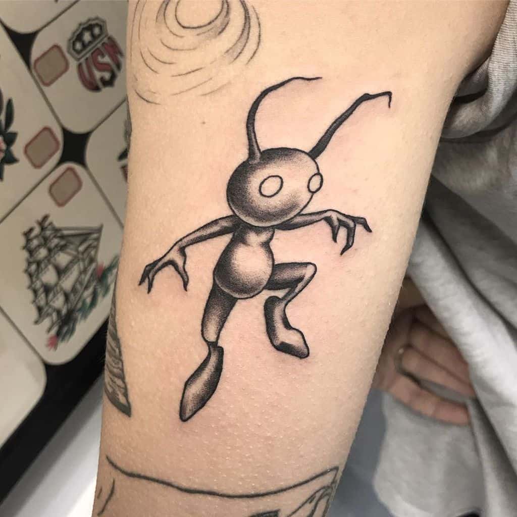 Black and grey Kingdom Hearts tattoo of a Shadow Heartless, featuring smooth shading and fine line details on the upper arm.