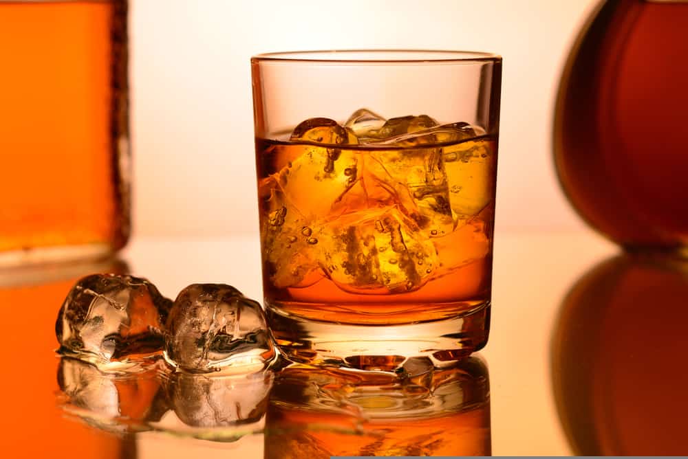 whiskey ice cubes near to whisky glass