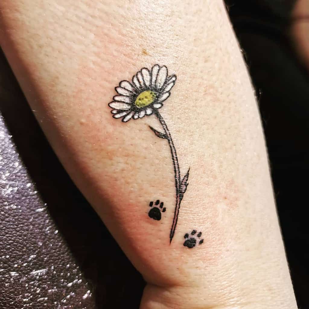 Wrist tattoo small simple color paw prints white and yellow daisy