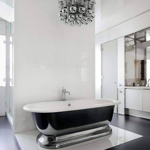 Modern bathroom with a black and white freestanding tub and a futuristic chrome light fixture