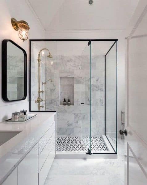 Modern bathroom with a glass shower, white and black tiles, and elegant fixtures