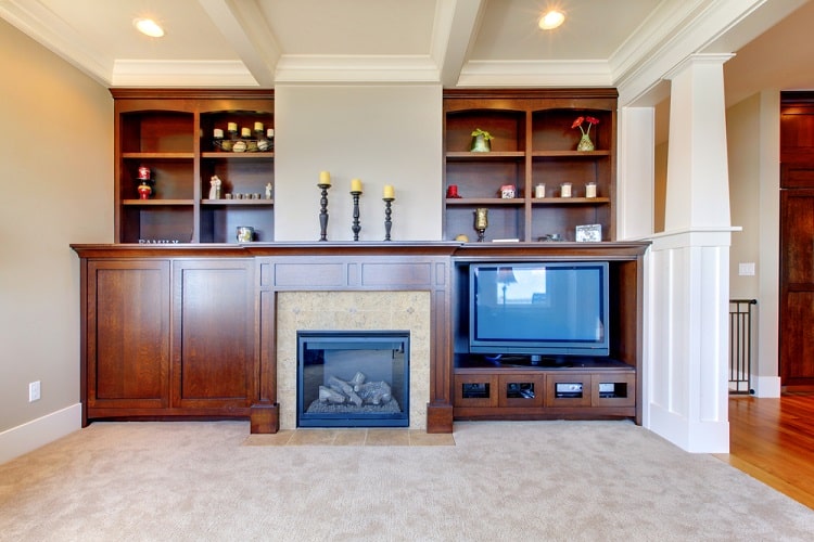 brown wood cabinet and shelving fireplace candles 