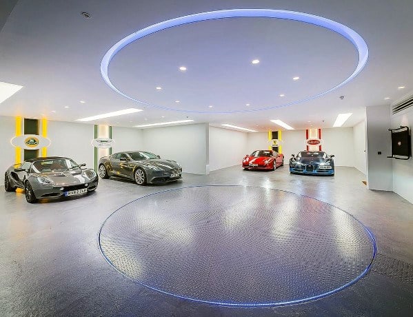 white drywall with painted car logos garage walls with sports cars led lighting 