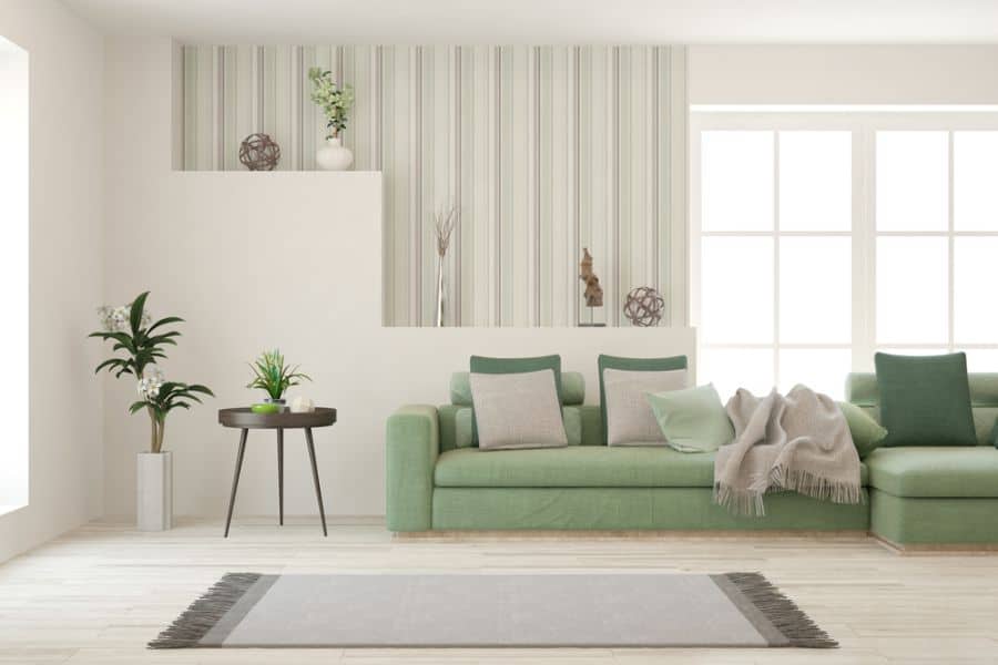 modern family room green sofa gray floor rug wallpaper feature wall plants 