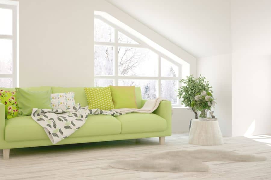 small attic living room green sofa plants 