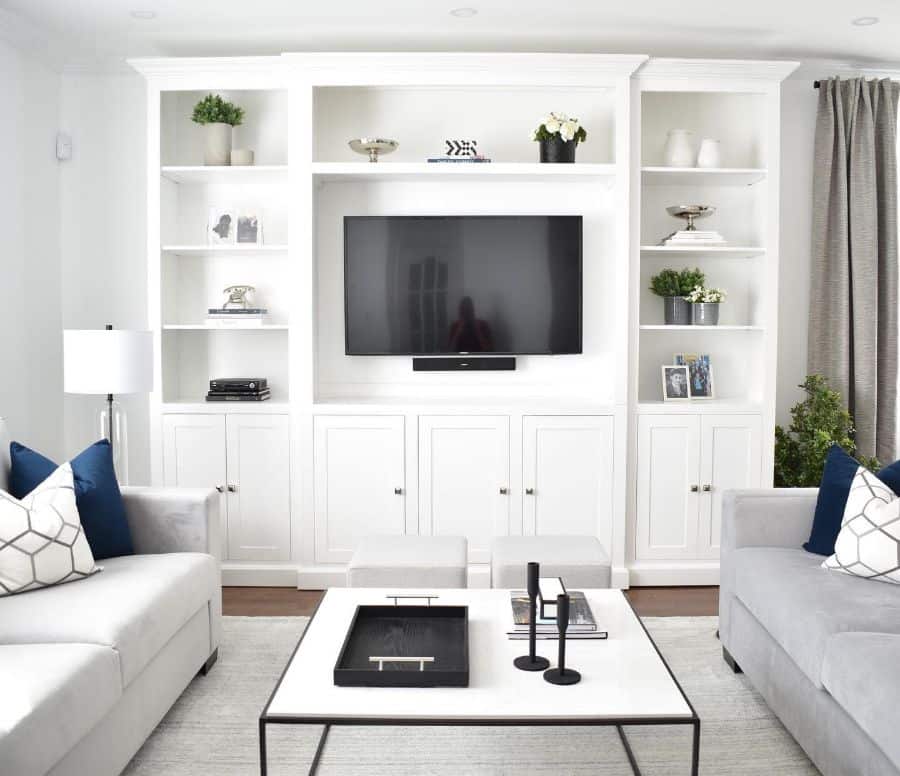 white family room large cabinet shelves sofas 