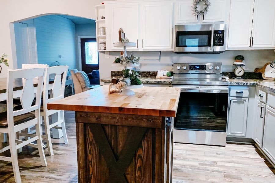white cabinet farmhouse kitchen with wood island