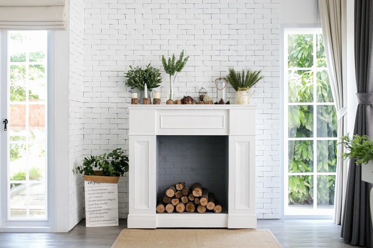 white brick wall with faux fireplace wood log storage