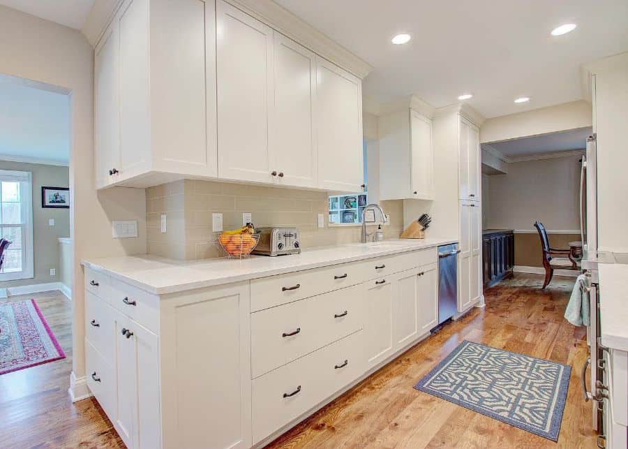 large white galley kitchen wood vinyl flooring blue floor rug