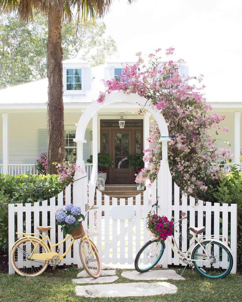 white garden gate with circle moon door design bicycles