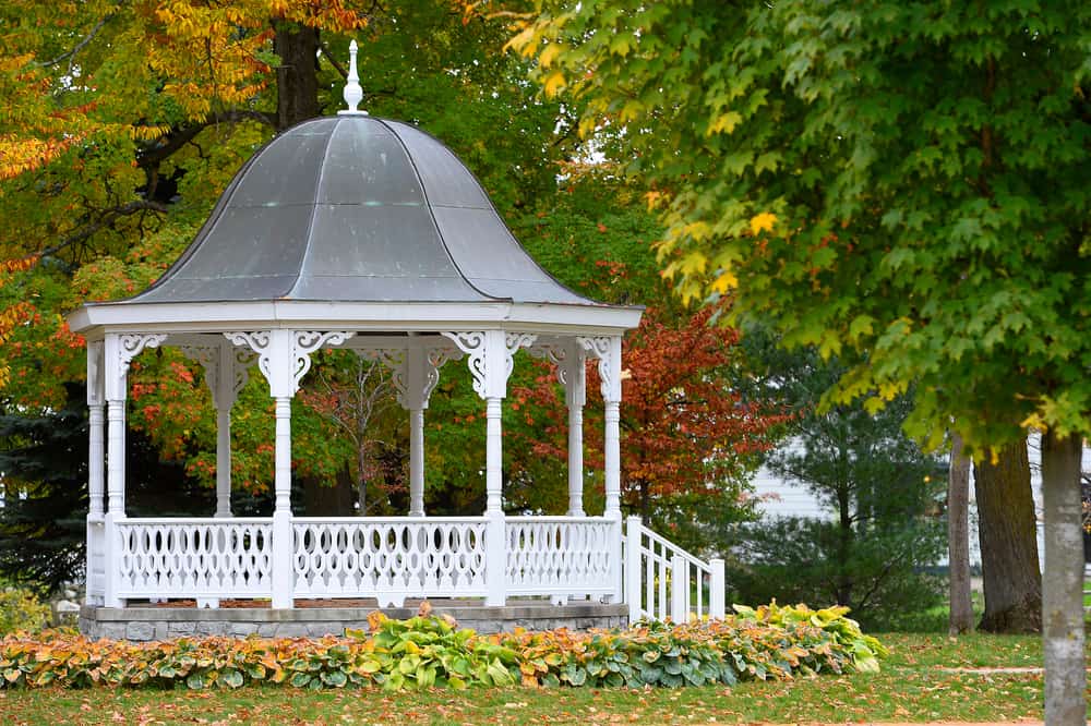 white wood gazebo sloped tin roof