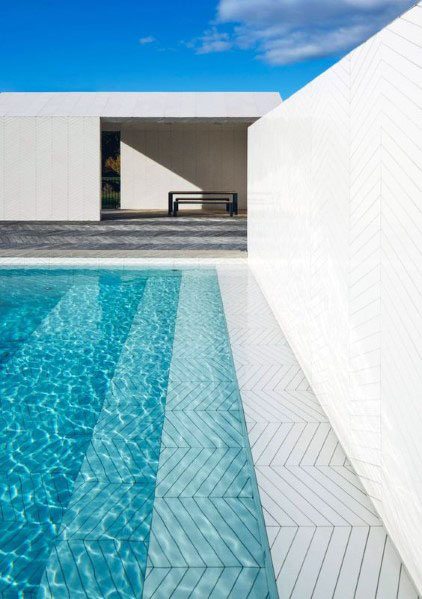 Minimalist pool with white geometric tiles and sleek modern aesthetics.