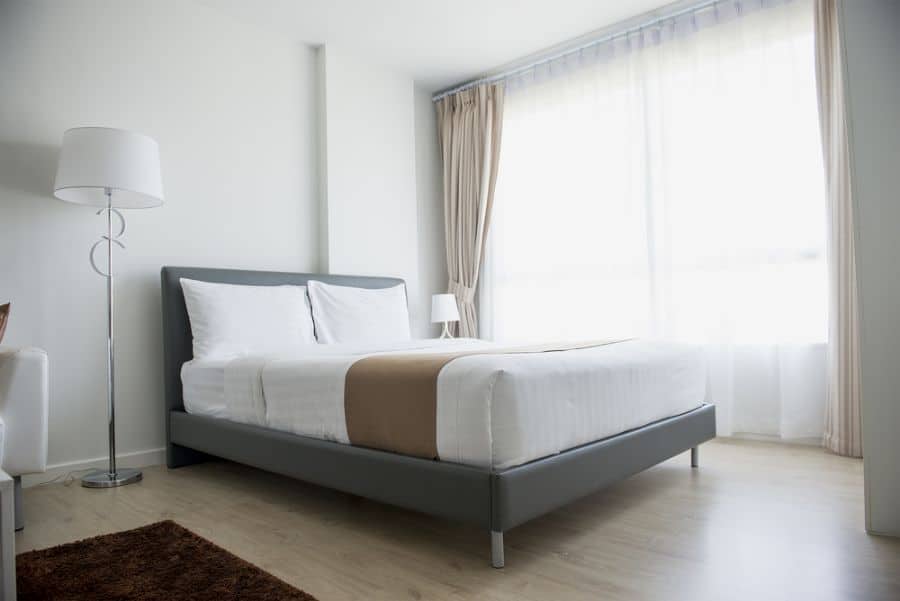 simple white bedroom gray bed frame vinyl wood floor