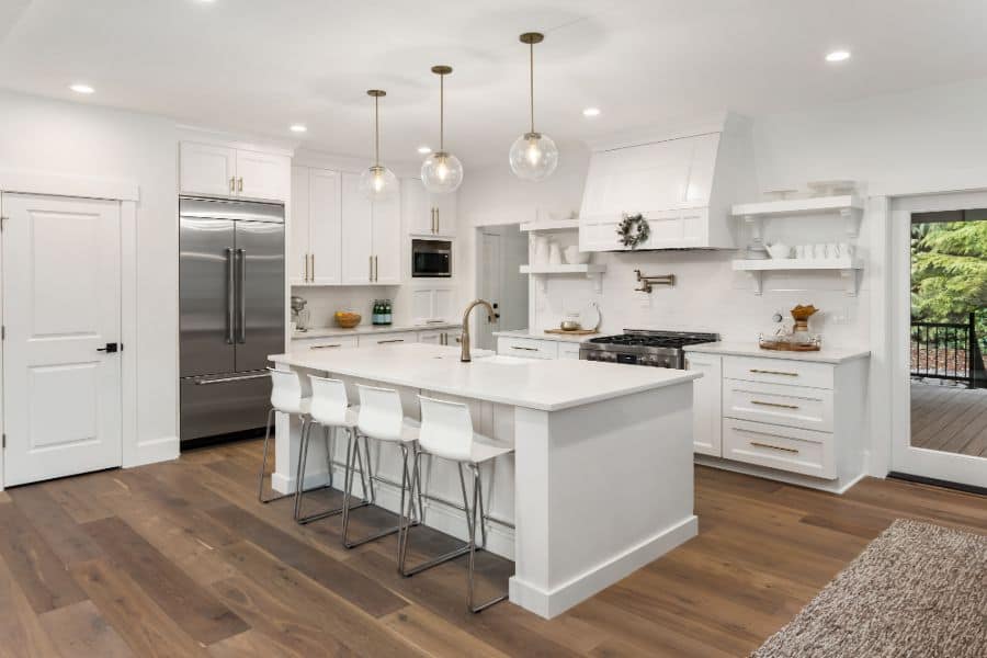 large modern white kitchen with silver fridge