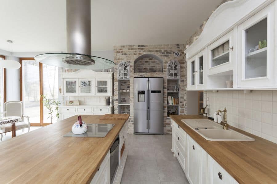 large open white kitchen with wood countertops
