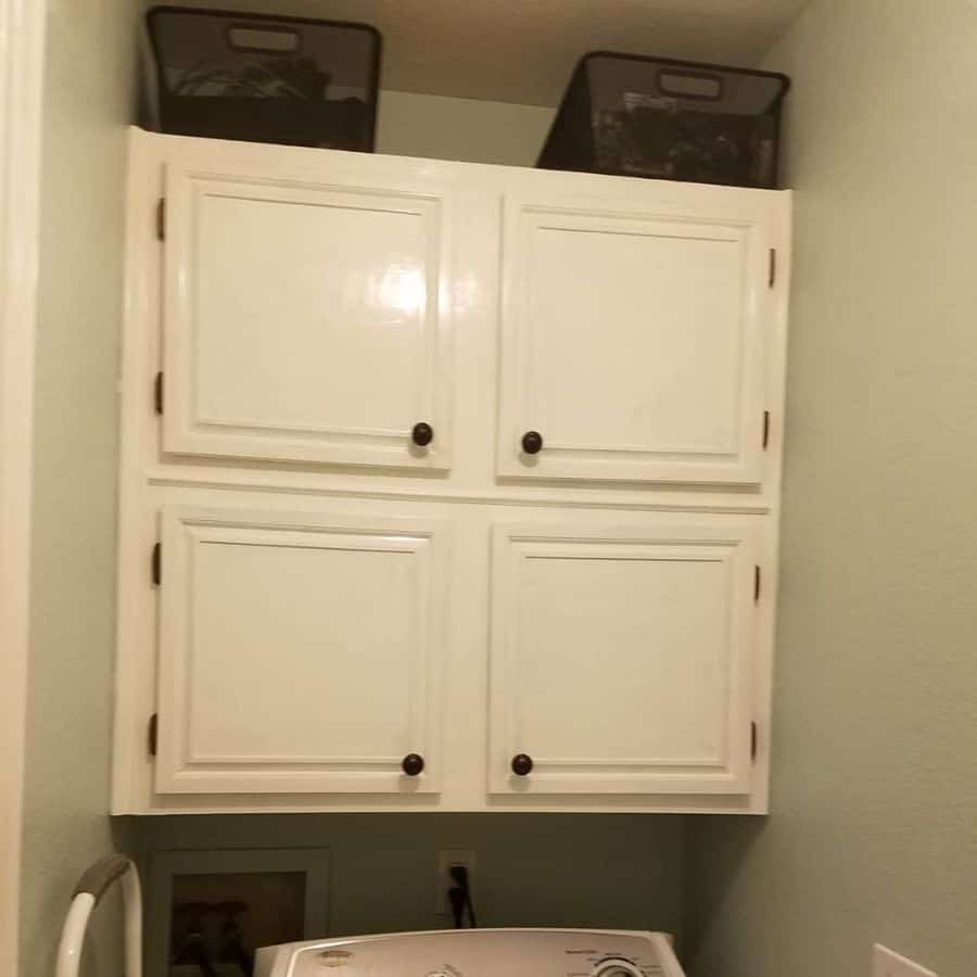 small laundry white wall cabinet